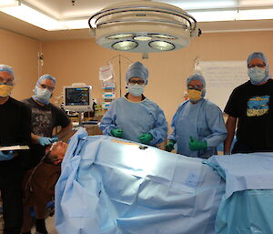 The station surgical team and pretend patient in the operating theatre during training.