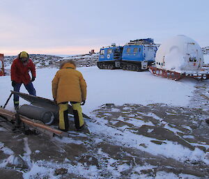 The old apple hut sits on a sled hitched to a Hägglunds ready for towing.