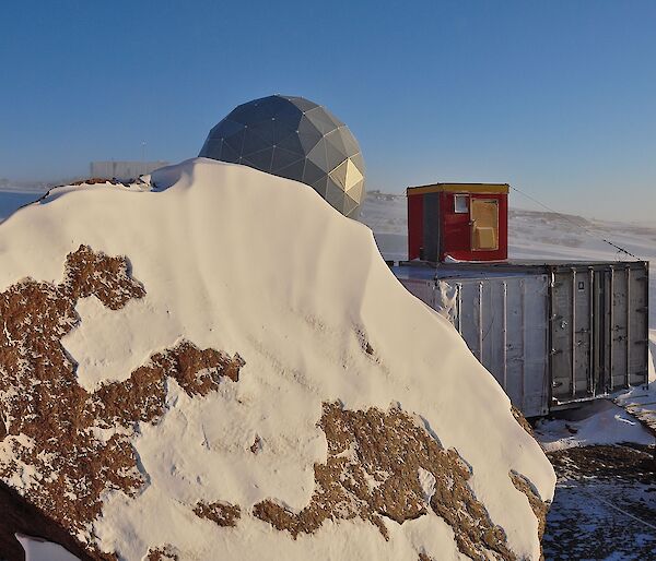 A view of the ANARESAT dome which is our link back to Australia and storage containers.