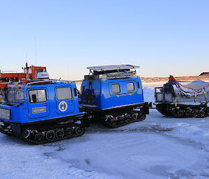 A Hägglunds vehicle is loaded and waiting on ice to travel to Bechervaise Island