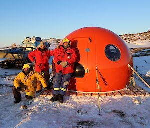 Peter Lecompte, Charlie Howell and Peter Layt pose outside of a small, newly constructed hut.