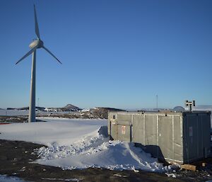 The wind turbine appears to watching over the Hydroponics building, a bit spooky.