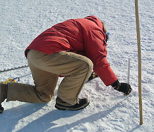 Kim measuring the depth of snow.
