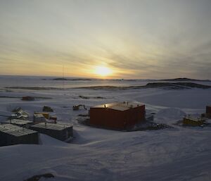 The sun in mid sky over station buildings