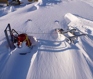 Sleds which are only just showing through the snow.