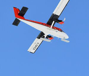 A small aircraft flying over the landing area on their way back to davis.