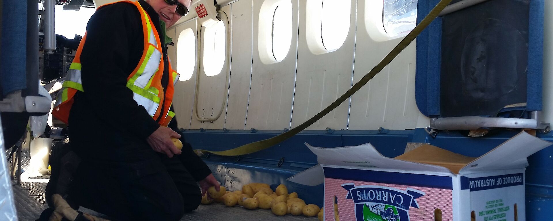 Russ the pilot picking spuds off the floor of the aircraft..