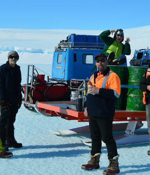 Smoko on the ice with ‘Angry’ while waiting for the aircraft to arrive. Not sure what Dorothy the Dinosaur is doing sitting on the fuel drums.