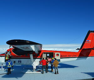 Unloading cargo from the side door of the aircraft.