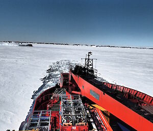 The Aurora Australis breaking through the ice and backing up before trying again — view is from the bow.