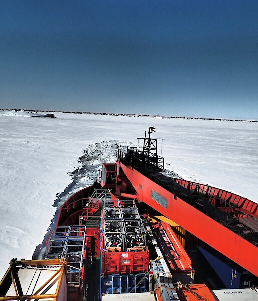 The Aurora Australis breaking through the ice and backing up before trying again — view is from the bow.