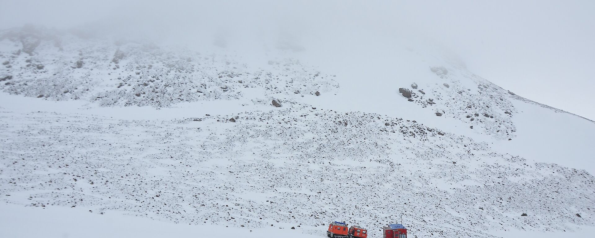 Fang Peak hidden behind cloud and the snow surrounding the hut and the Hagglands.