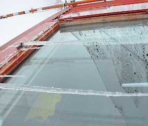 Long thin icicles over the hut window.