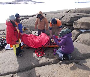 The patient in the stretcher.