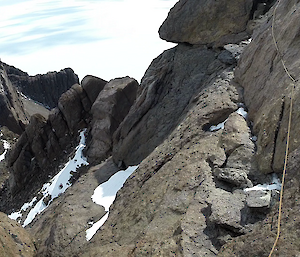 A view from a rocky cliff down to an icy landscape