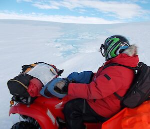 Peter watching the melt on the ice plateau from his quad bike..