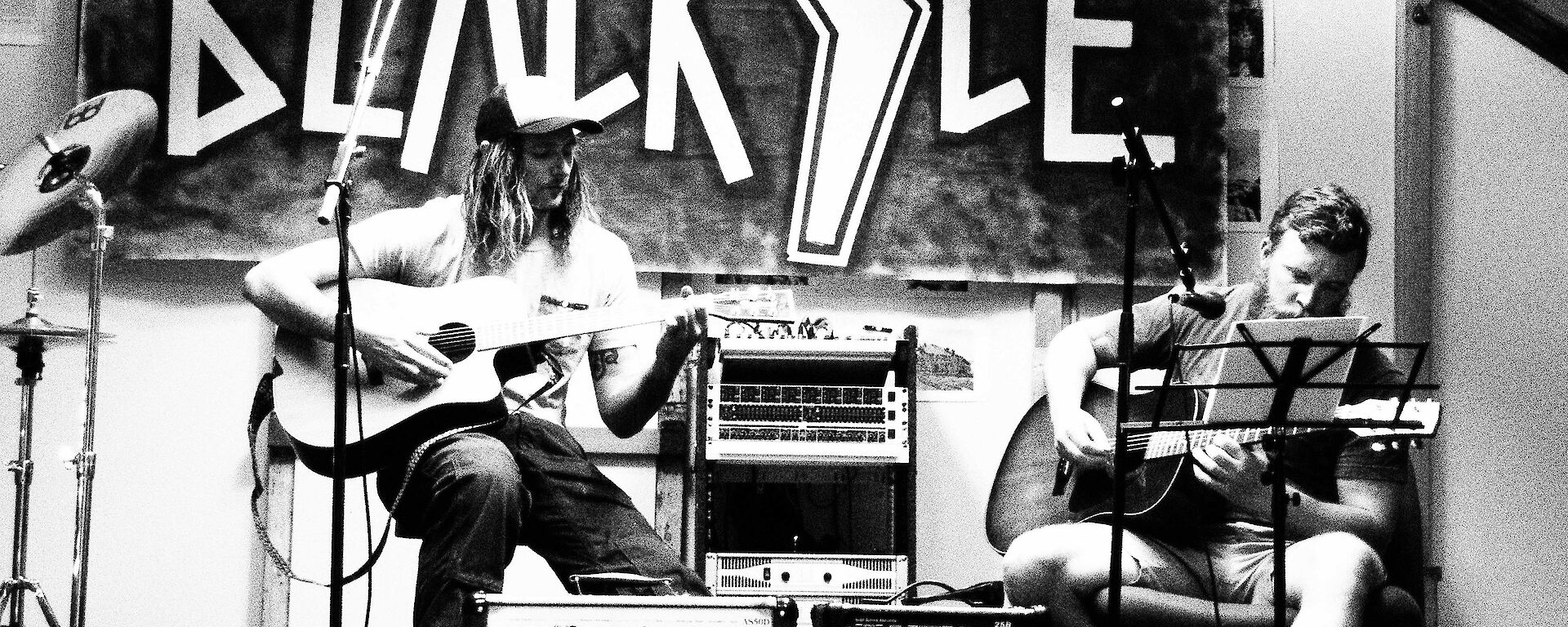 A black and white image of James and Sam opening with an acoustic set.