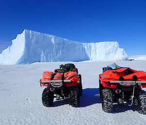 Admiring the icebergs scattered through the sea ice with the two red Honda quads in front.