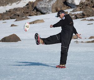 Kim kicking the football on the ice at Rumdoodle.