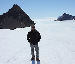 Sam at Phillips Ridge with the Central Masson Range behind him.