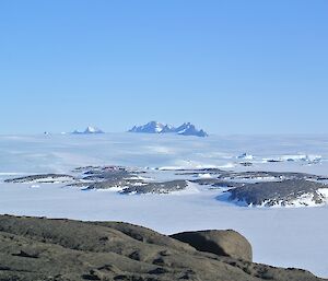 The view of the station and the David Range from the summit on Welch Island shows rocky peaks sticking out from the ice