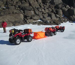 Two quad bikes with an orange bivvy (smallt tent) roped in between