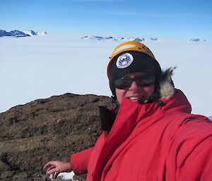 A man standing on top of Fang Peak taking a selfie