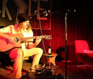 Young man playing an aucostic guitar