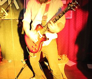 A man playing an electric guitar