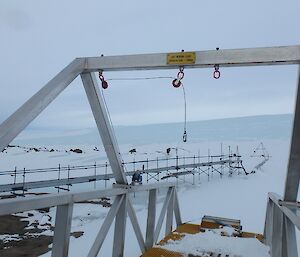 a large steel frame next to some pipework with a small steel prism in distance