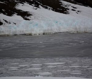 A channel of water with larger pieces of ice floating