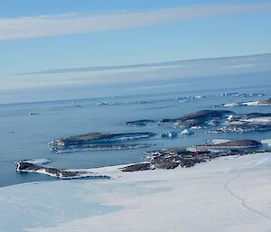 Horseshoe shaped harbour in the distance and from above