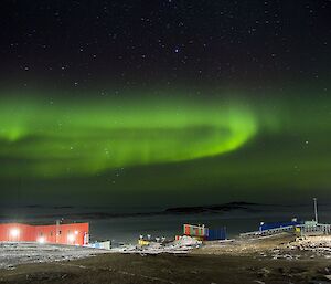 A green aurora above the red shed