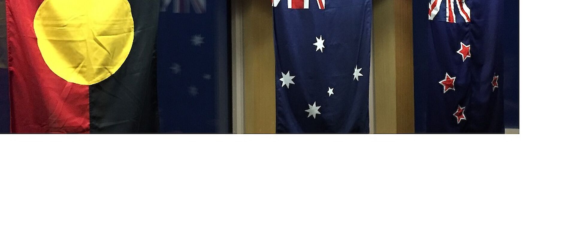 The Australian flag hung in the middle of the New Zealand flag and the Australian Aboriginal flag