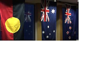 The Australian flag hung in the middle of the New Zealand flag and the Australian Aboriginal flag