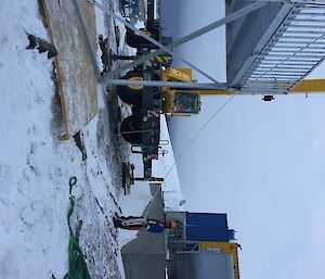 A man in high vis holding a rope attached to the steel platform