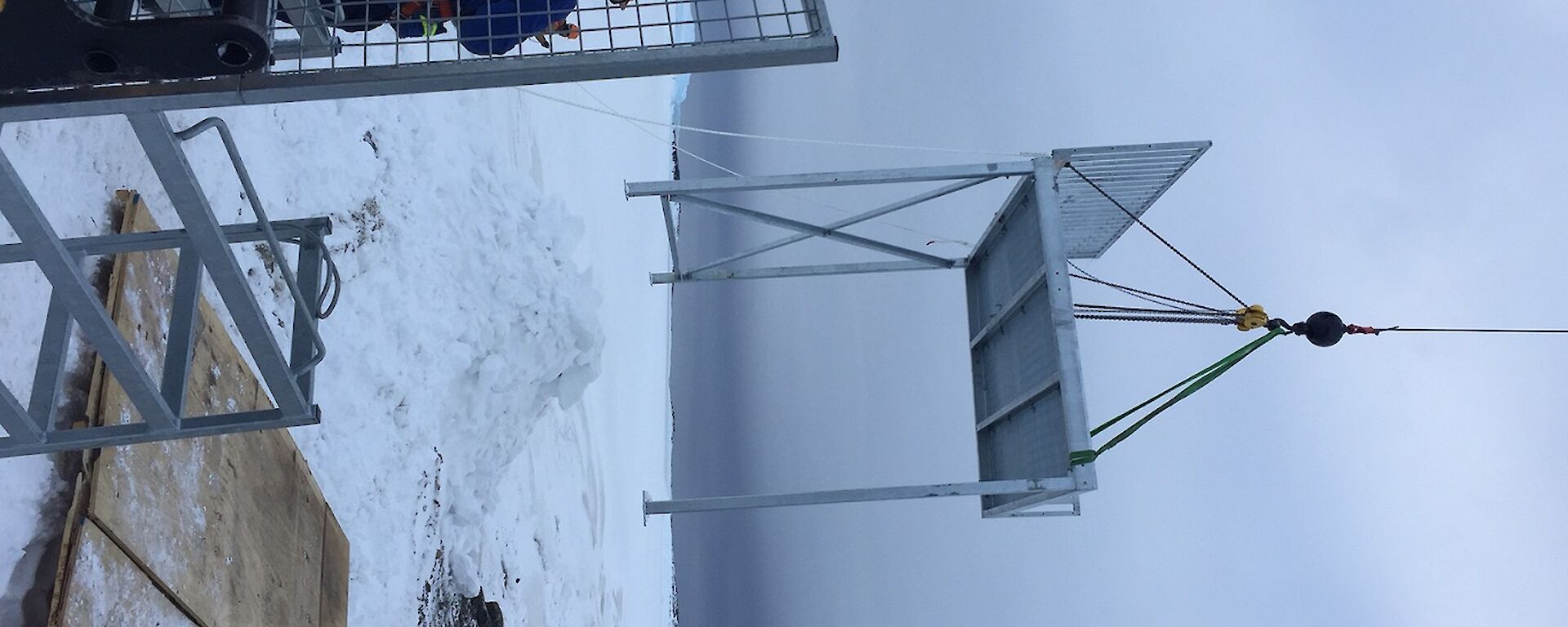 A steel platform being lifted by a crane