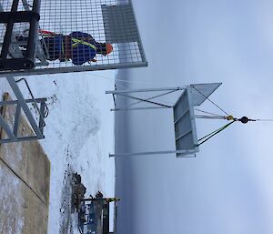 A steel platform being lifted by a crane