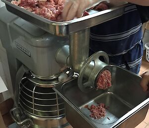 A meat grinder making pork mince