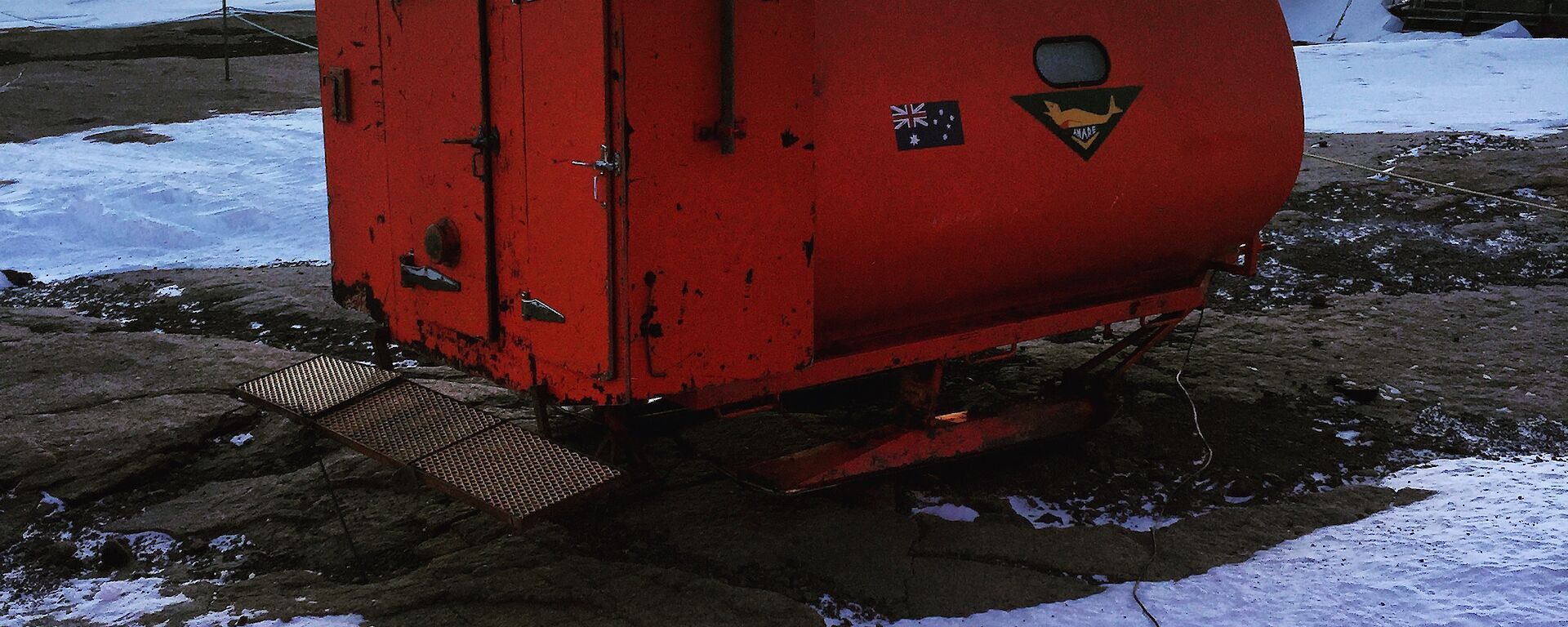 a round orange hut mounted on skids