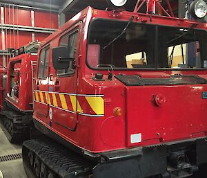 a red hagglund with yellow and red stripes up the side