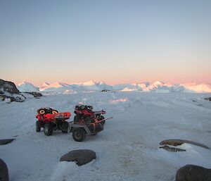A quad bike sitting in front of lots of ice bergs
