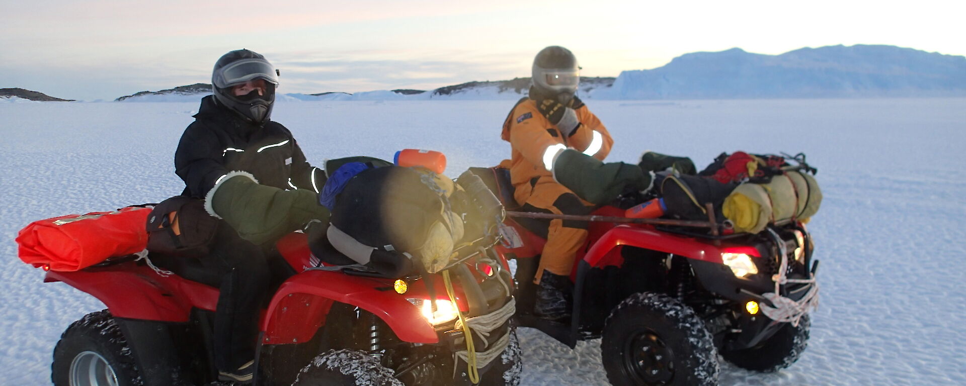 Two people on quad bikes with lots of layers on