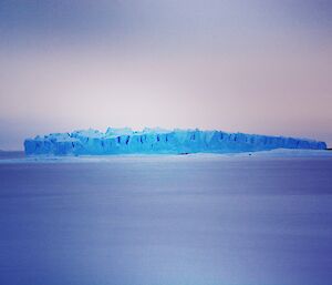 A large ice berg with a ridged top