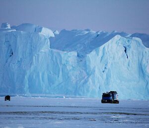 a hagg and a quad driving past a glacier edge