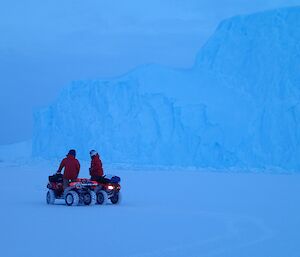 two quad bikes in front of a ice berg