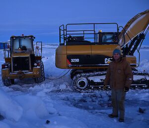 An excavator getting a jump start