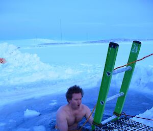 a expeditioner getting into the icy water