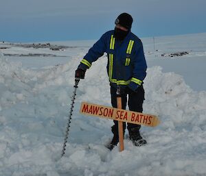 A sign ‘mawson sea baths’ being placed in the ice