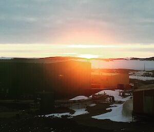 a sunrise over a large shed